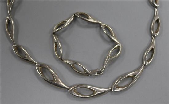 A contemporary silver necklace and matching bracelet.